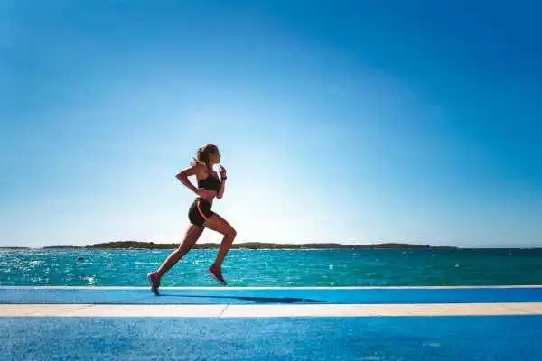 Woman running showing strong leg muscle Greenford